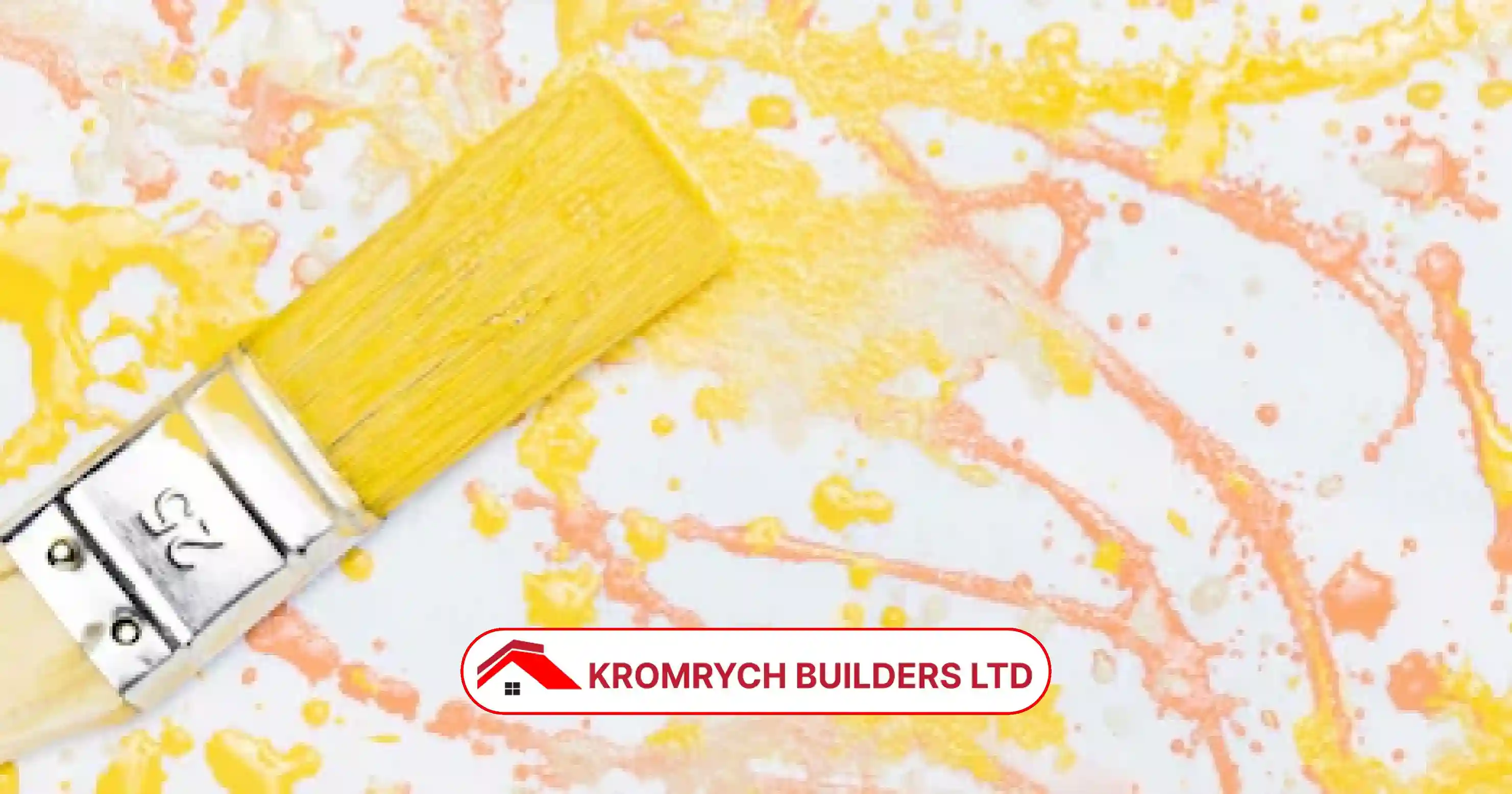 Yellow paintbrush with decorative orange and yellow paint splashes, representing creative decorative painting techniques by Kromrych Builders.